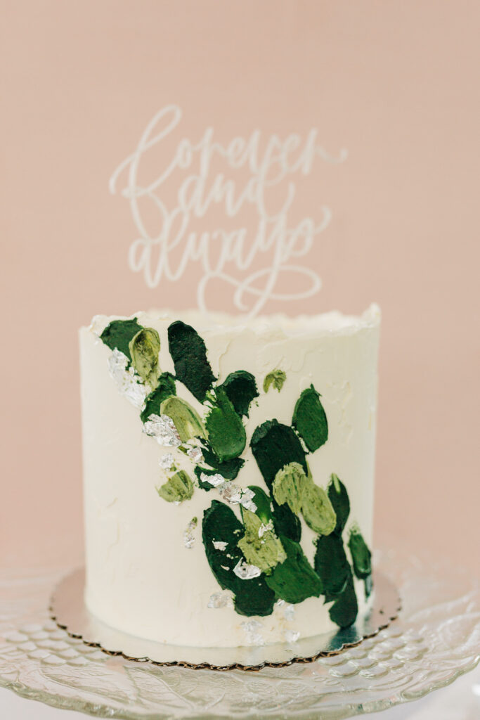 small wedding cake with green accents