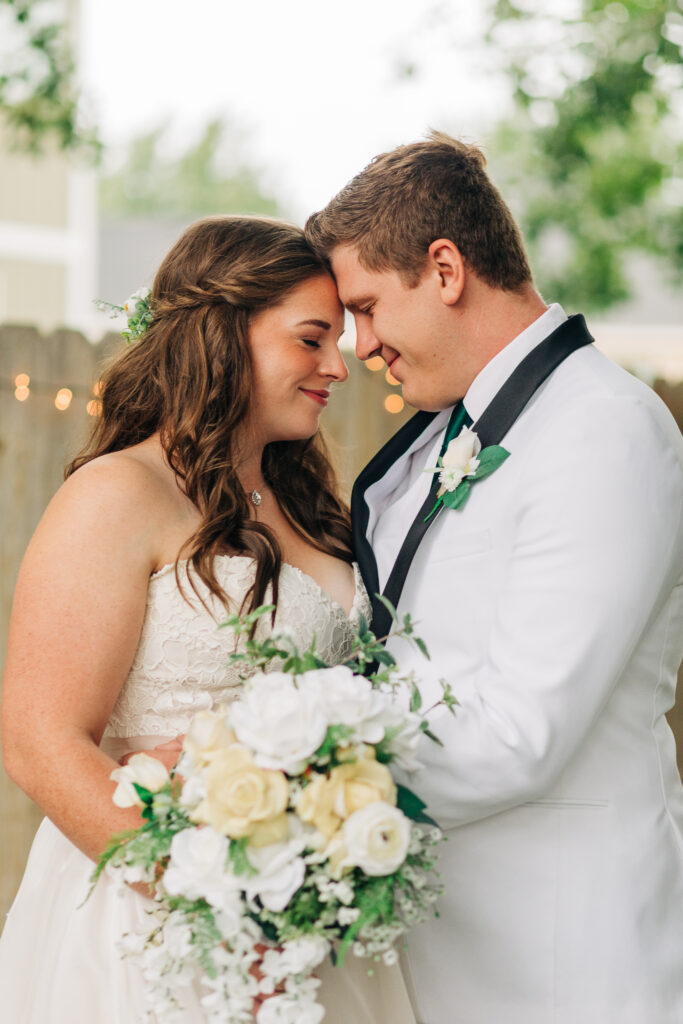 Beautiful bride and groom during their outdoor wedding day with fall themed wedding decor and unique wedding reception location