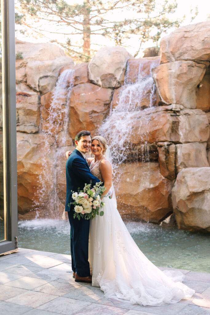 bride and groom portraits in front of waterfall
