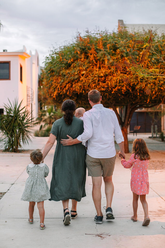 sweet family walking in a small colonial style town in Mexico