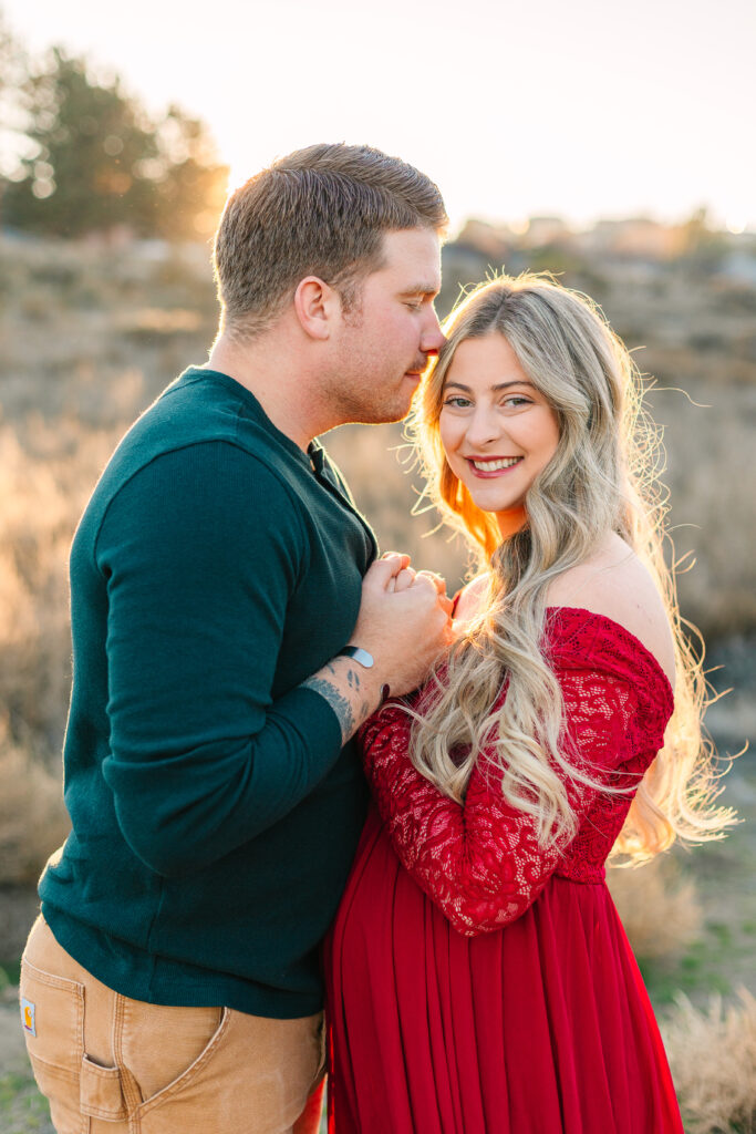Zach guides Anne Marie into a patch of sunlight, adding a natural glow to their heartwarming outdoor maternity session.