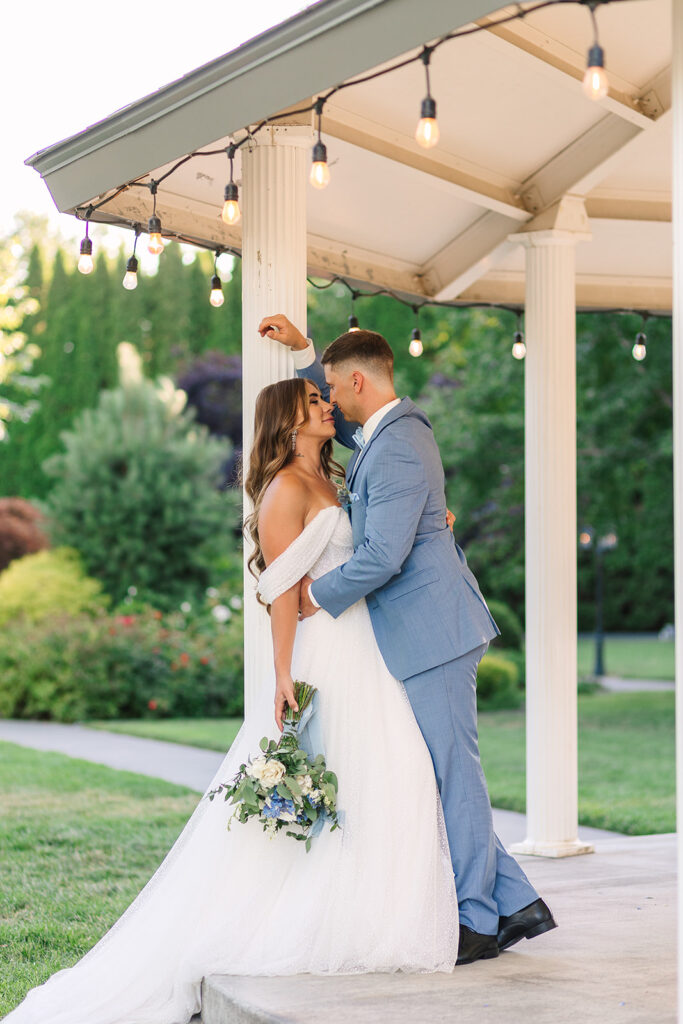 Couple stands under a gazebo at a tri-cities wedding venue