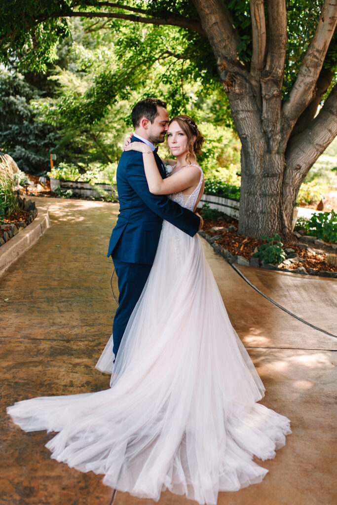 A couple poses on a brown pathway at a wedding venue near tri-cities 