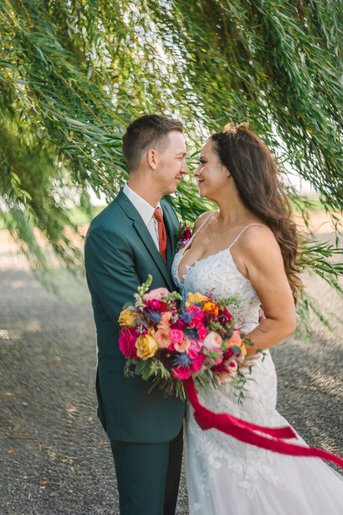 Couple standing in front of the willow tree at a tri-cities wedding venue